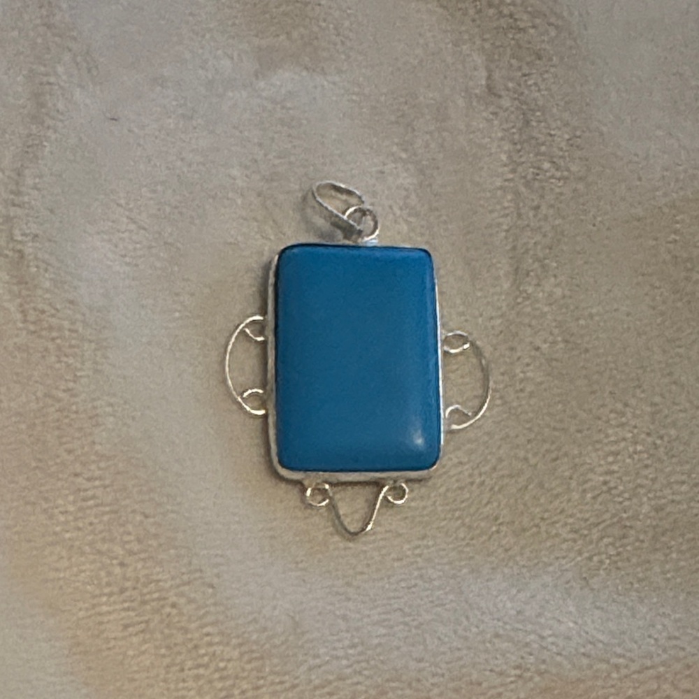 Elegant Blue Pendant set in silver with Silver Accents